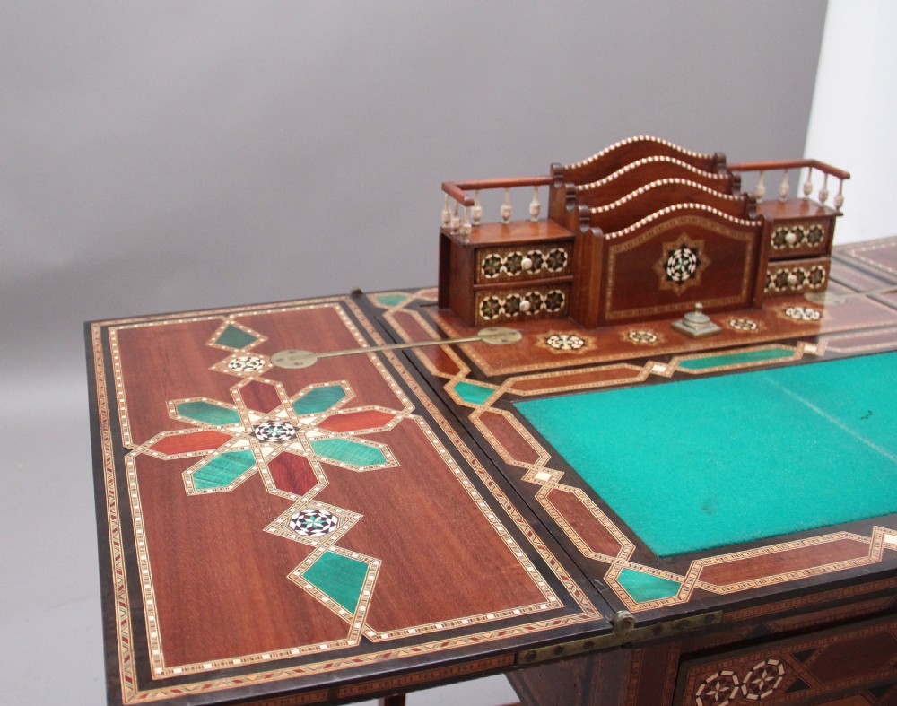 A 19th-century Syrian metamorphic writing table with geometric mother-of-pearl inlay, side flap leaves, and a green writing surface. View XIV
