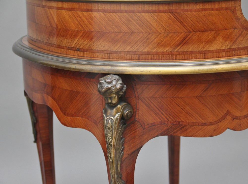 A 19th-century French kingwood writing table featuring ornate gilt-bronze mounts, cabriole legs, a green leather inset top, and a raised shelving superstructure. View XIII
