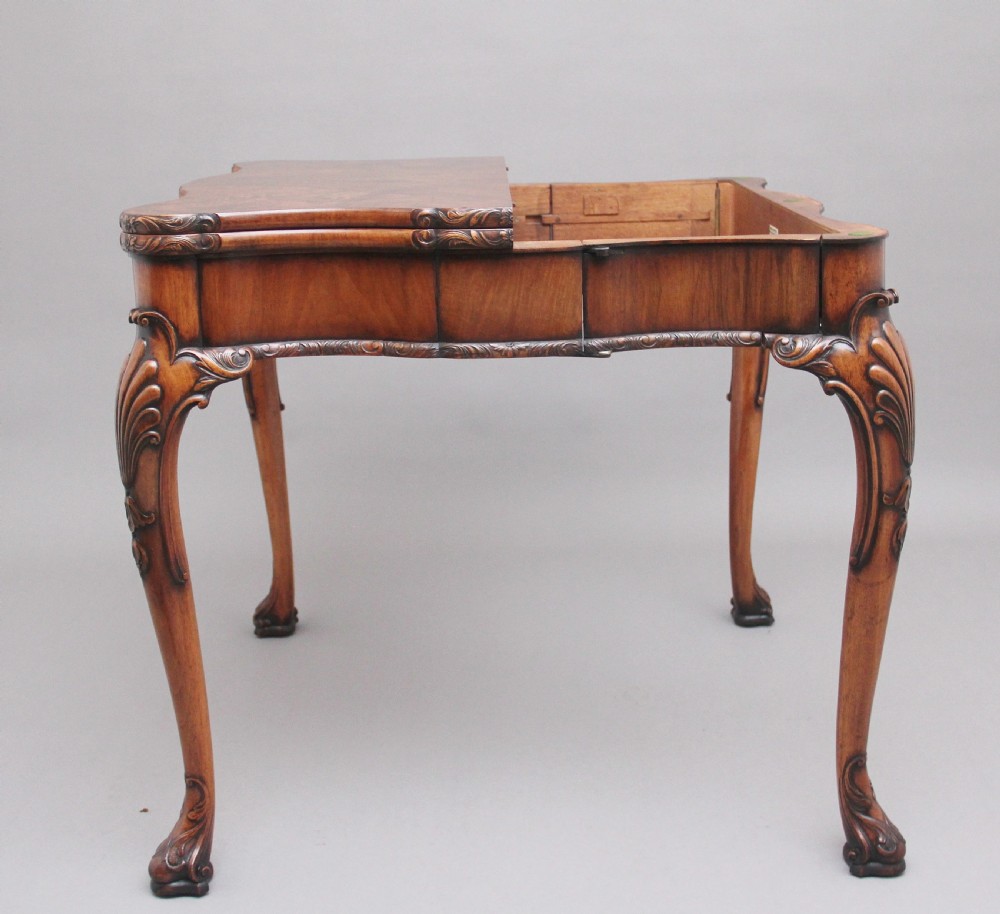 An early twentieth-century carved walnut card table featuring cabriole legs with shell motifs and a contoured apron. View III