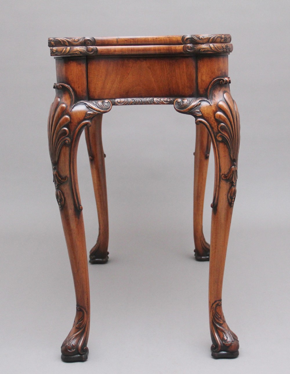An early twentieth-century carved walnut card table featuring cabriole legs with shell motifs and a contoured apron. View VII