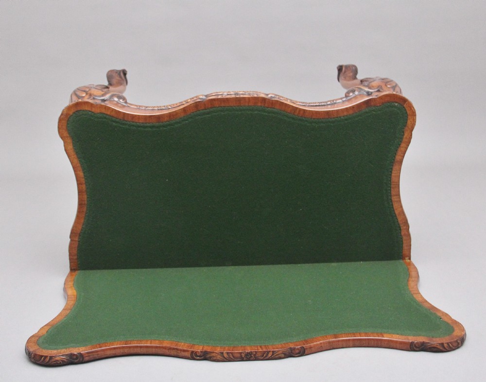 An early twentieth-century carved walnut card table featuring cabriole legs with shell motifs and a contoured apron. View XI