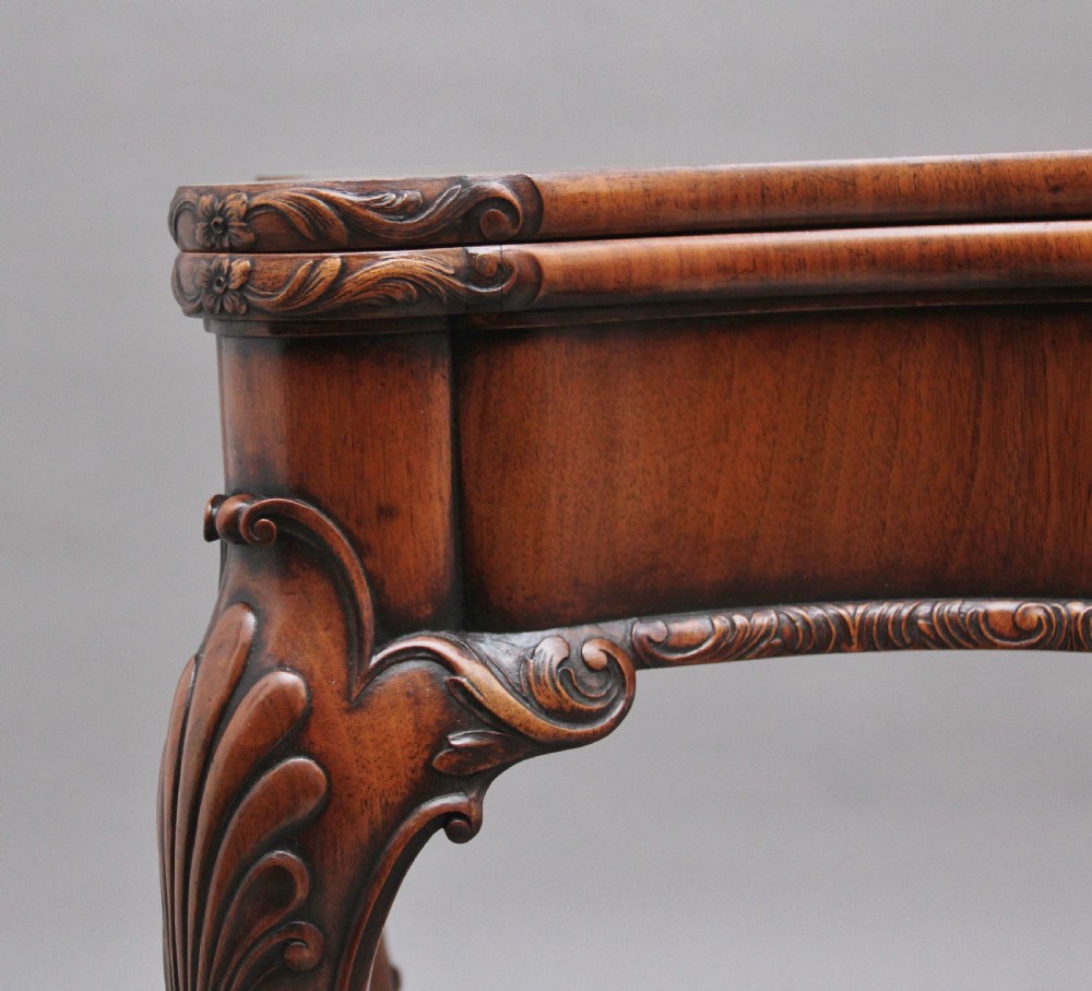 An early twentieth-century carved walnut card table featuring cabriole legs with shell motifs and a contoured apron. View XII