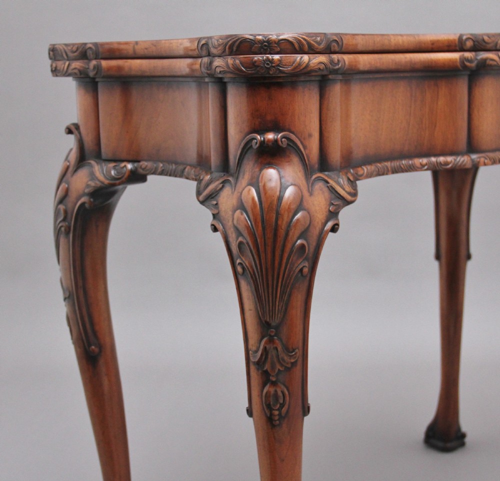 An early twentieth-century carved walnut card table featuring cabriole legs with shell motifs and a contoured apron. View XIII