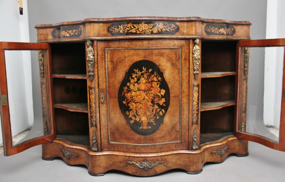 A 19th-century burr walnut credenza featuring a central door with floral marquetry inlay, flanked by two curved glazed doors and detailed ormolu mounts. View II