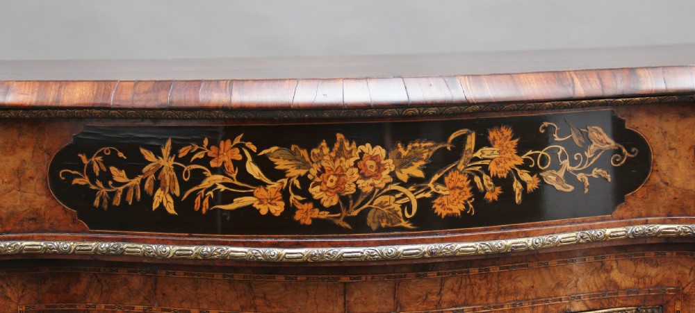 A 19th-century burr walnut credenza featuring a central door with floral marquetry inlay, flanked by two curved glazed doors and detailed ormolu mounts. View XIV