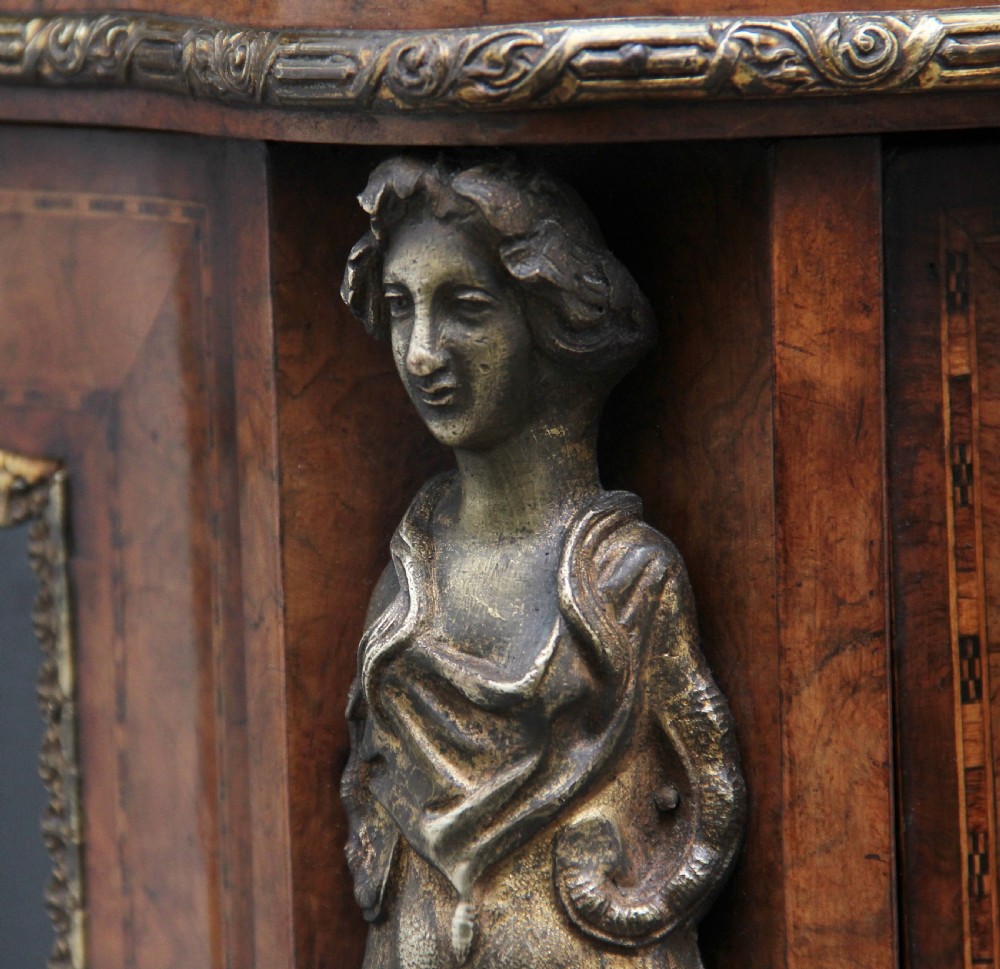 A 19th-century burr walnut credenza featuring a central door with floral marquetry inlay, flanked by two curved glazed doors and detailed ormolu mounts. View XVII