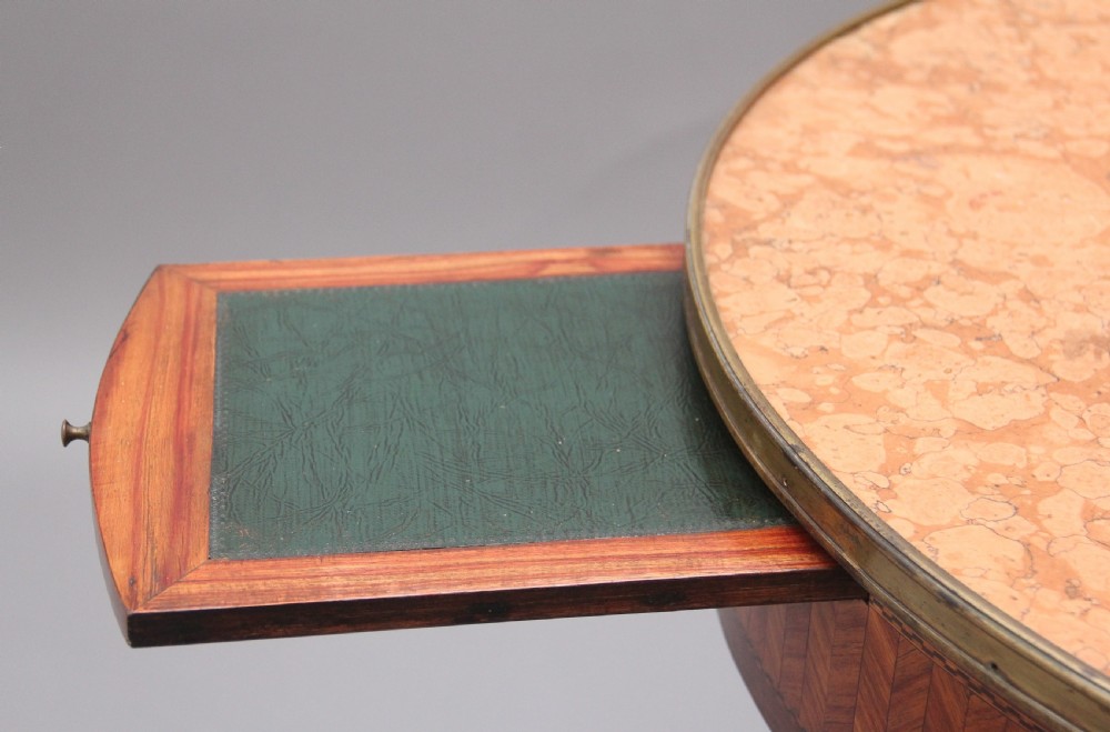 A 19th-century French oval centre table featuring kingwood parquetry, tapered square legs, a single drawer, and a brass gallery top rim. View IV