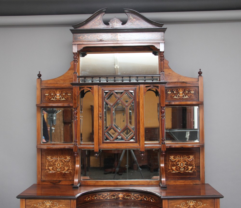 A 19th-century rosewood display cabinet featuring intricate marquetry urn inlays, mirror backs, lattice glazed doors, and a broken pediment top. View III