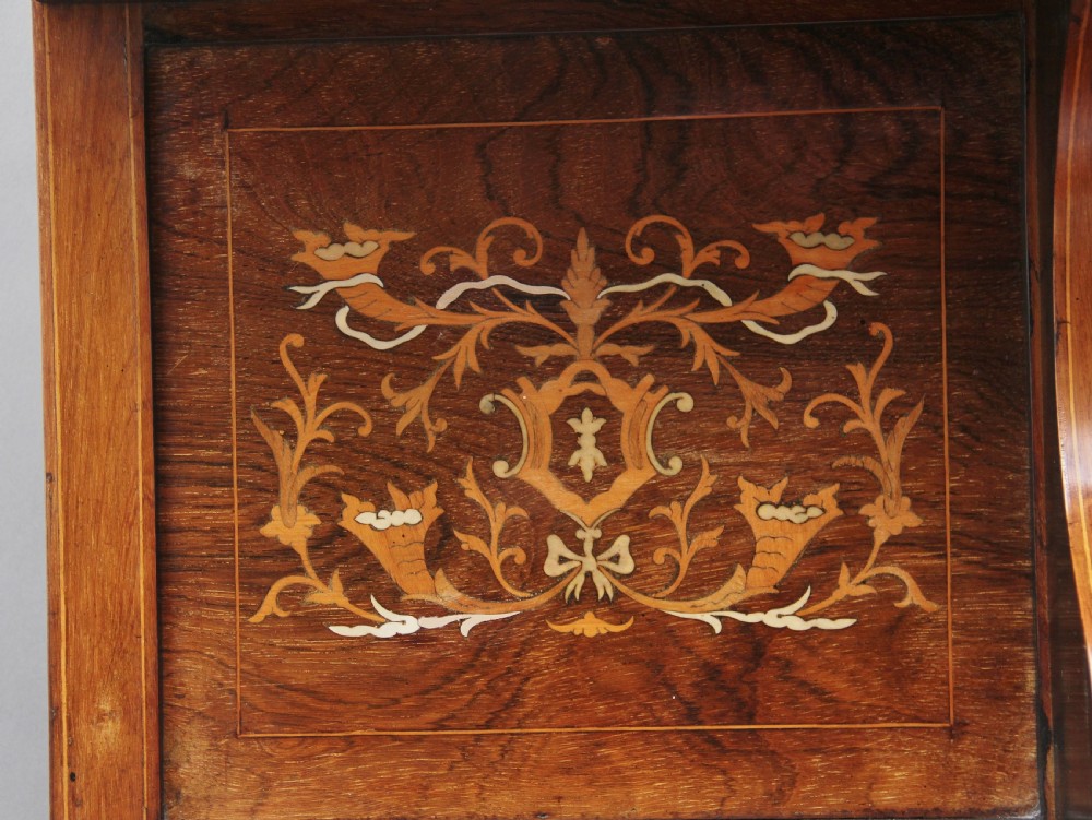 A 19th-century rosewood display cabinet featuring intricate marquetry urn inlays, mirror backs, lattice glazed doors, and a broken pediment top. View XIV