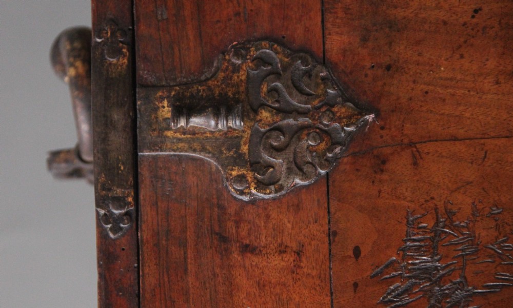 A seventeenth-century Spanish walnut vargueno writing cabinet featuring intricate wrought iron lockplates and handles resting on a turned trestle stand. View XIV