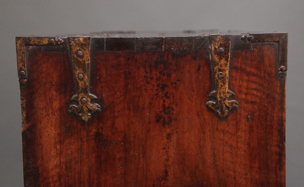 A seventeenth-century Spanish walnut vargueno writing cabinet featuring intricate wrought iron lockplates and handles resting on a turned trestle stand. View XXIV