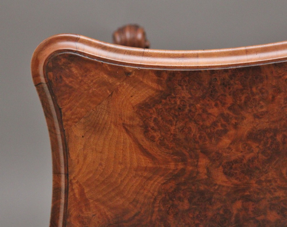 A 19th-century burr walnut centre table featuring a serpentine top and elaborate carved scroll supports joined by a turned stretcher. View XI