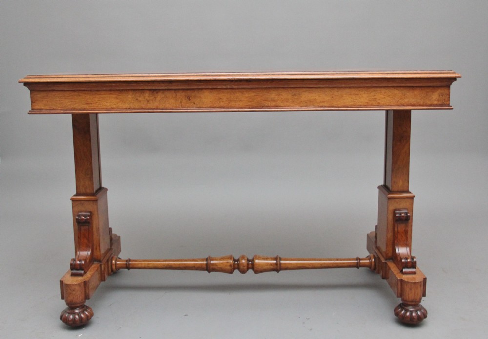 An early 19th-century pollard oak dumb waiter featuring three rectangular tiered shelves supported by upright pillars and a carved trestle base with lobed feet. View III
