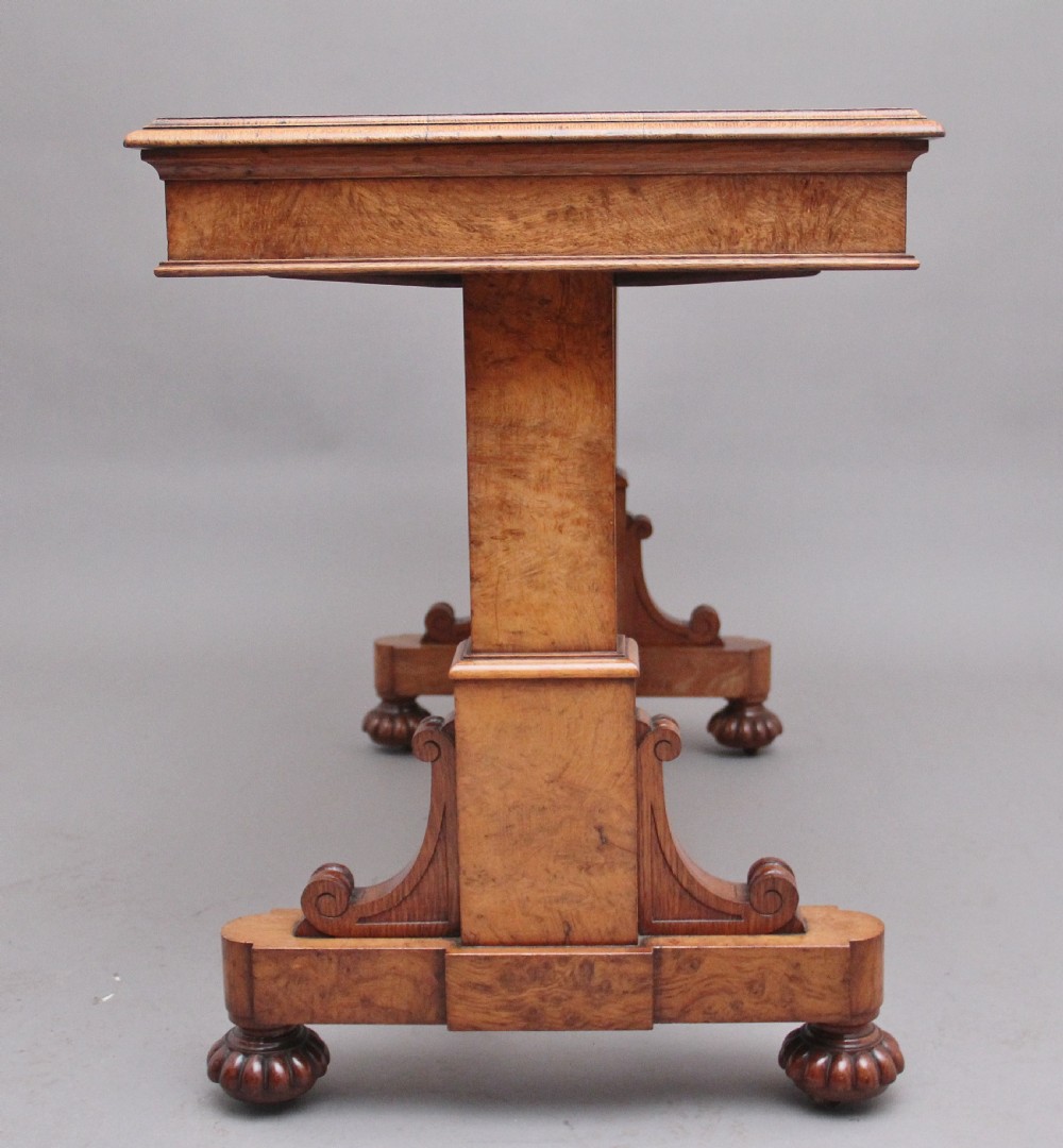 An early 19th-century pollard oak dumb waiter featuring three rectangular tiered shelves supported by upright pillars and a carved trestle base with lobed feet. View VIII