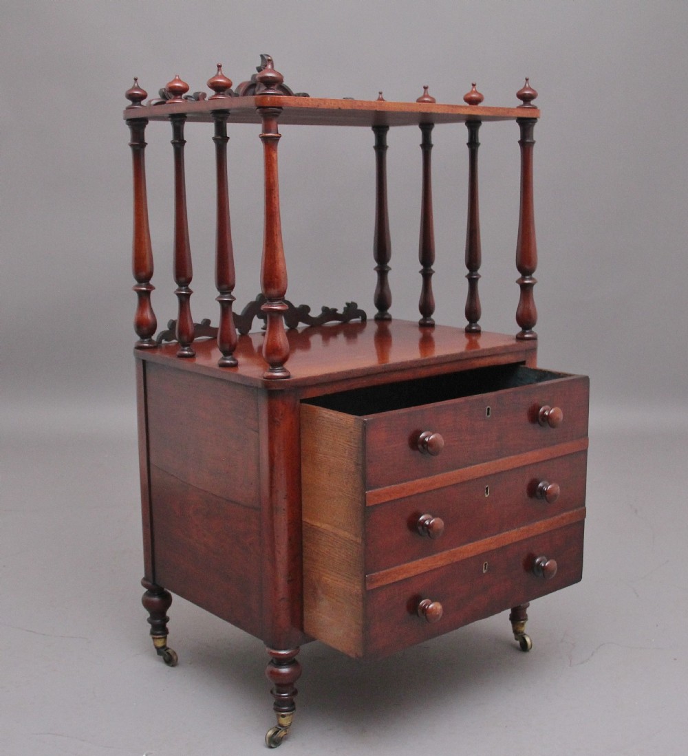 A 19th-century mahogany whatnot with open turned-spindle top shelf over three drawers raised on brass castors. View II