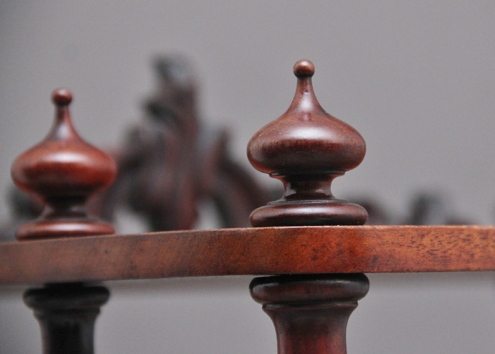 A 19th-century mahogany whatnot with open turned-spindle top shelf over three drawers raised on brass castors. View X