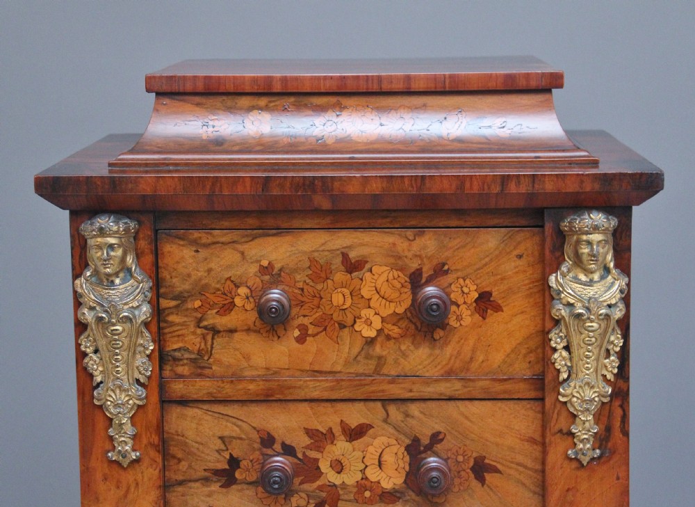 A tall, narrow Victorian walnut Wellington chest featuring six drawers decorated with floral marquetry inlays and cast ormolu mounts. View V