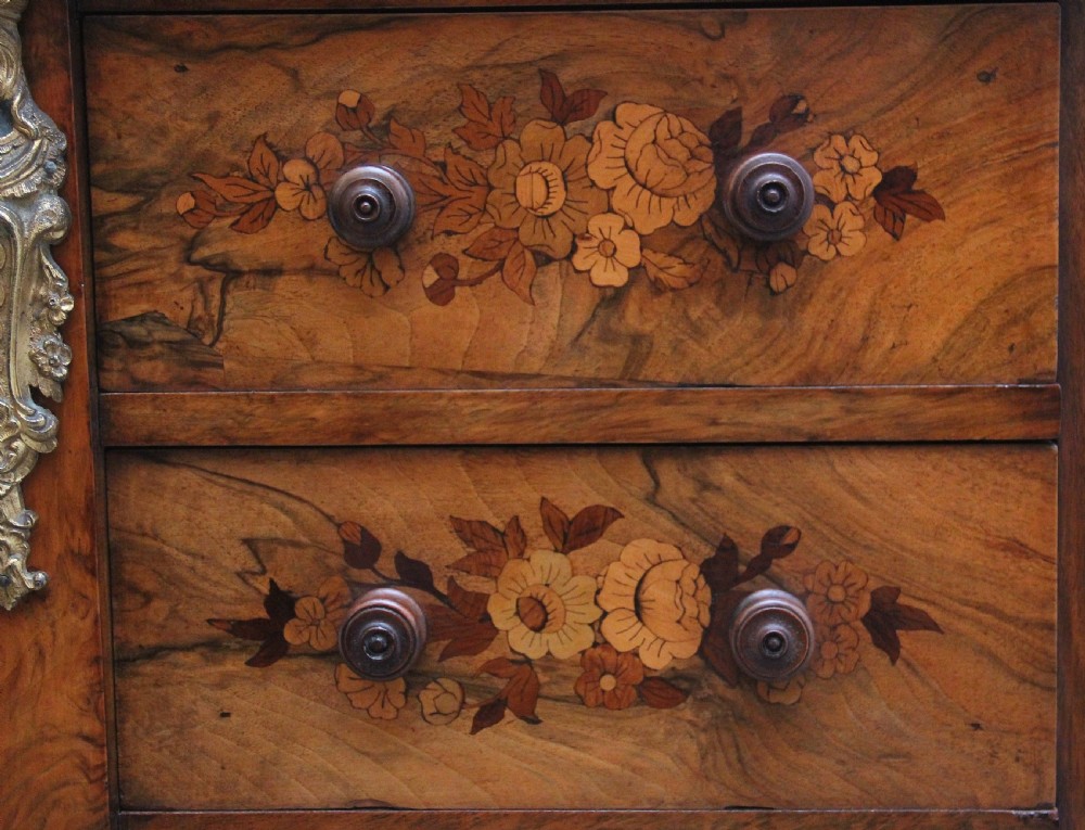 A tall, narrow Victorian walnut Wellington chest featuring six drawers decorated with floral marquetry inlays and cast ormolu mounts. View VII