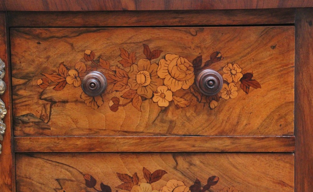 A tall, narrow Victorian walnut Wellington chest featuring six drawers decorated with floral marquetry inlays and cast ormolu mounts. View VIII