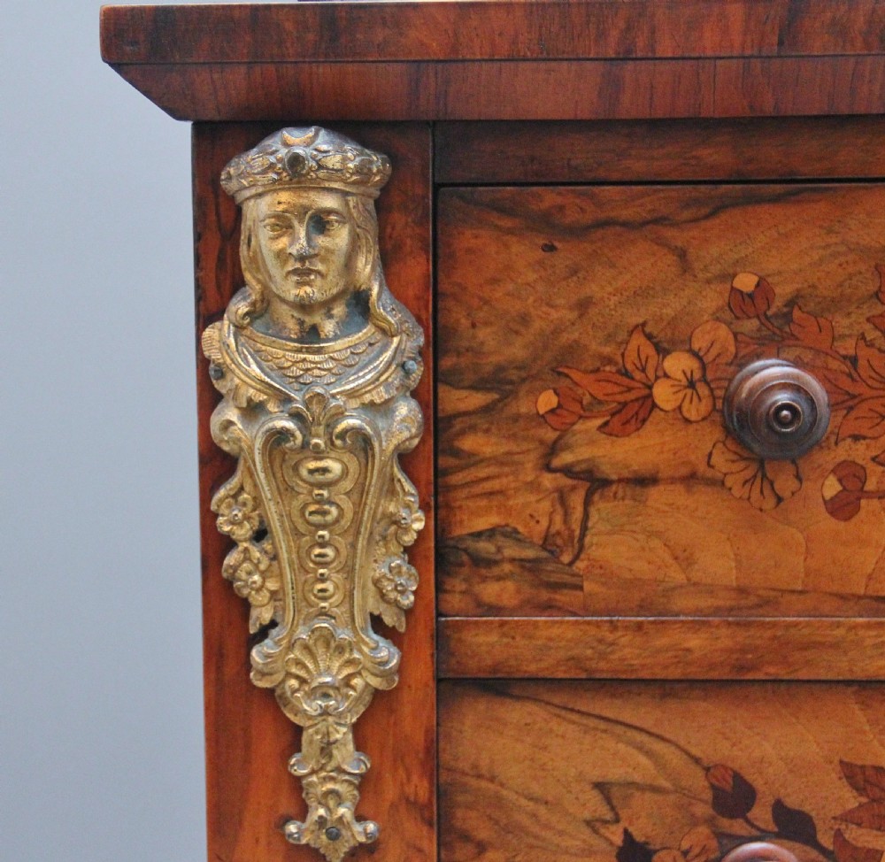 A tall, narrow Victorian walnut Wellington chest featuring six drawers decorated with floral marquetry inlays and cast ormolu mounts. View IX