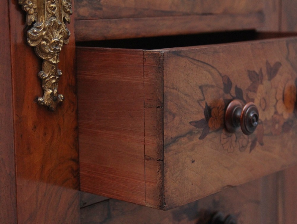 A tall, narrow Victorian walnut Wellington chest featuring six drawers decorated with floral marquetry inlays and cast ormolu mounts. View XII