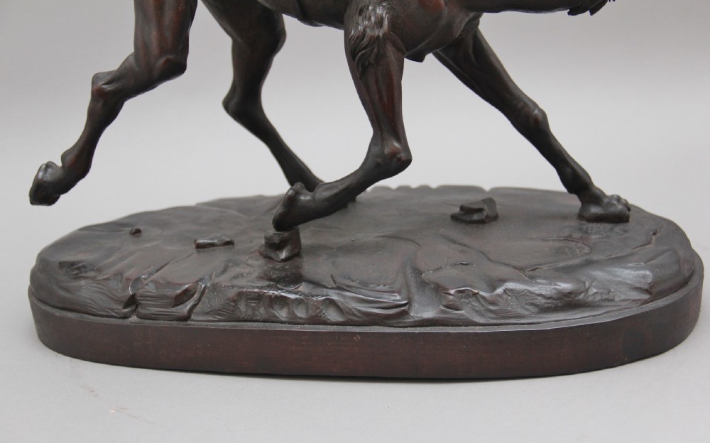A 19th-century dark carved wood sculpture depicting a figure mounted on a striding camel upon an oval base. View XIII
