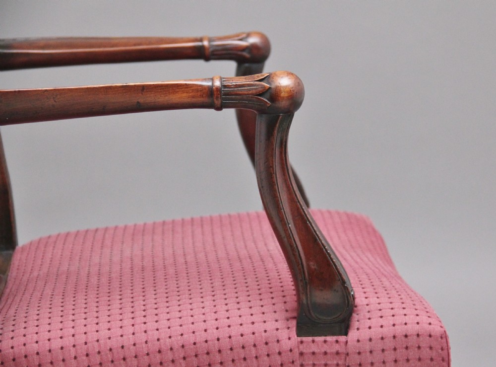 A set of dark mahogany dining armchairs featuring intricate anthemion carved back splats, curved arms, and pink patterned upholstered seats. View XI