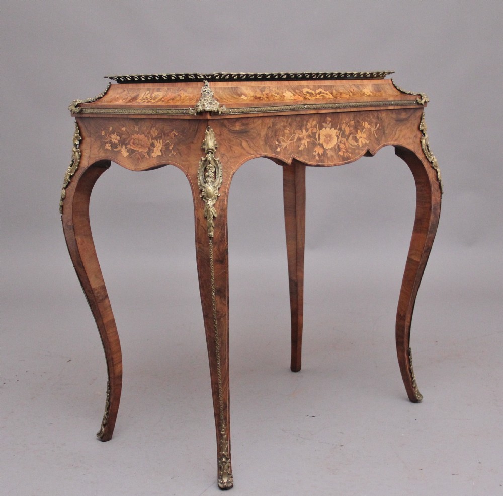 A 19th-century French Louis XV style burr walnut jardiniere table with floral marquetry inlay, brass gallery top, and gilt bronze mounts on cabriole legs. View II