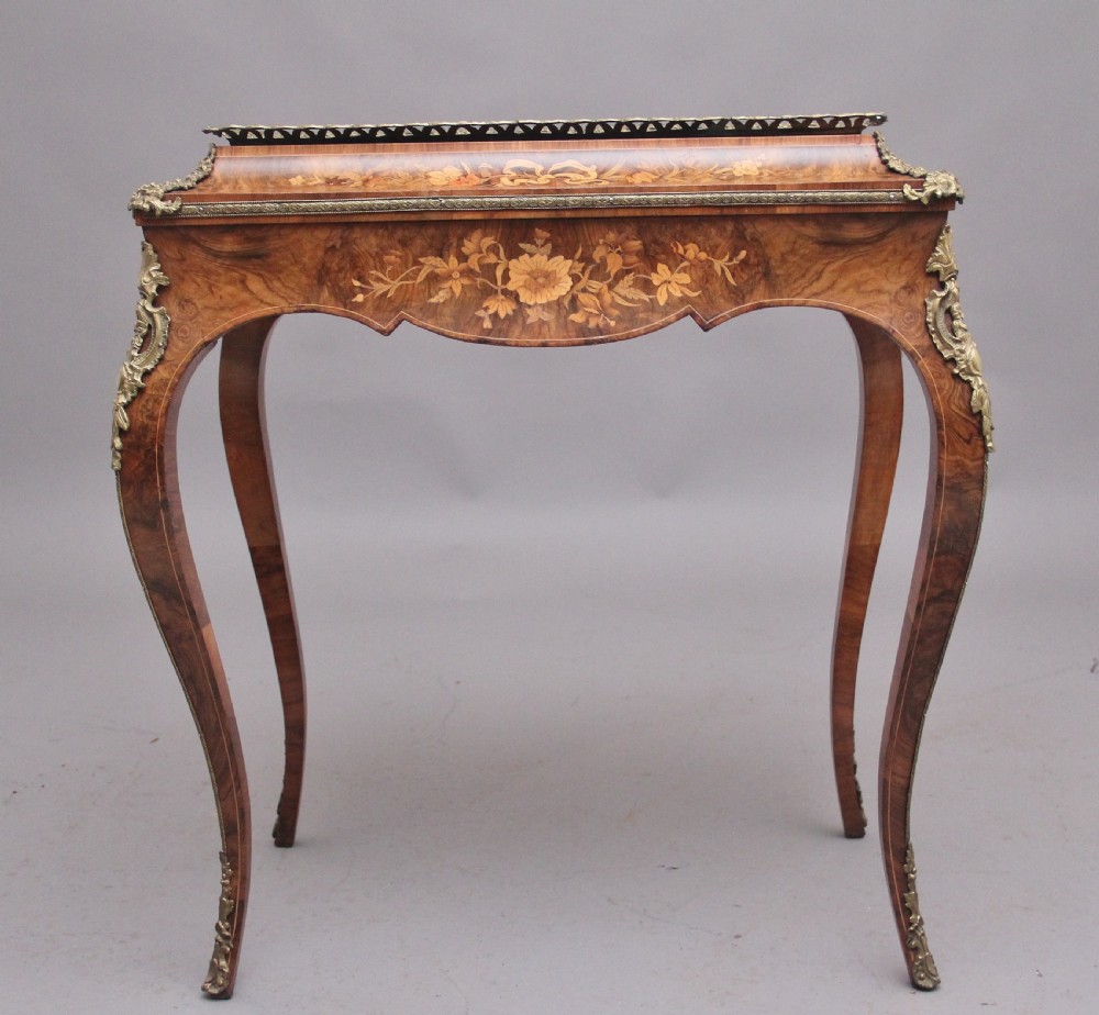 A 19th-century French Louis XV style burr walnut jardiniere table with floral marquetry inlay, brass gallery top, and gilt bronze mounts on cabriole legs. View III