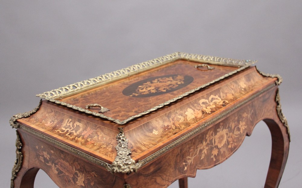 A 19th-century French Louis XV style burr walnut jardiniere table with floral marquetry inlay, brass gallery top, and gilt bronze mounts on cabriole legs. View IV