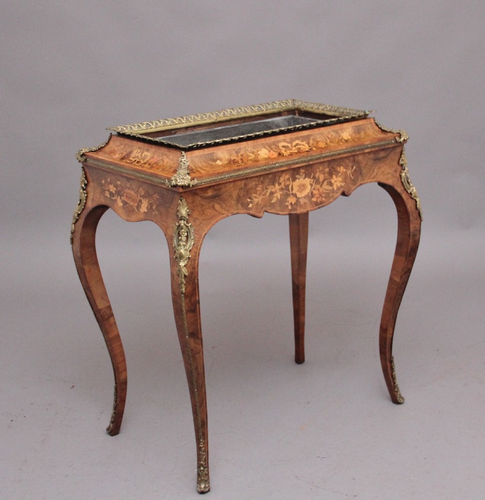A 19th-century French Louis XV style burr walnut jardiniere table with floral marquetry inlay, brass gallery top, and gilt bronze mounts on cabriole legs. View VIII