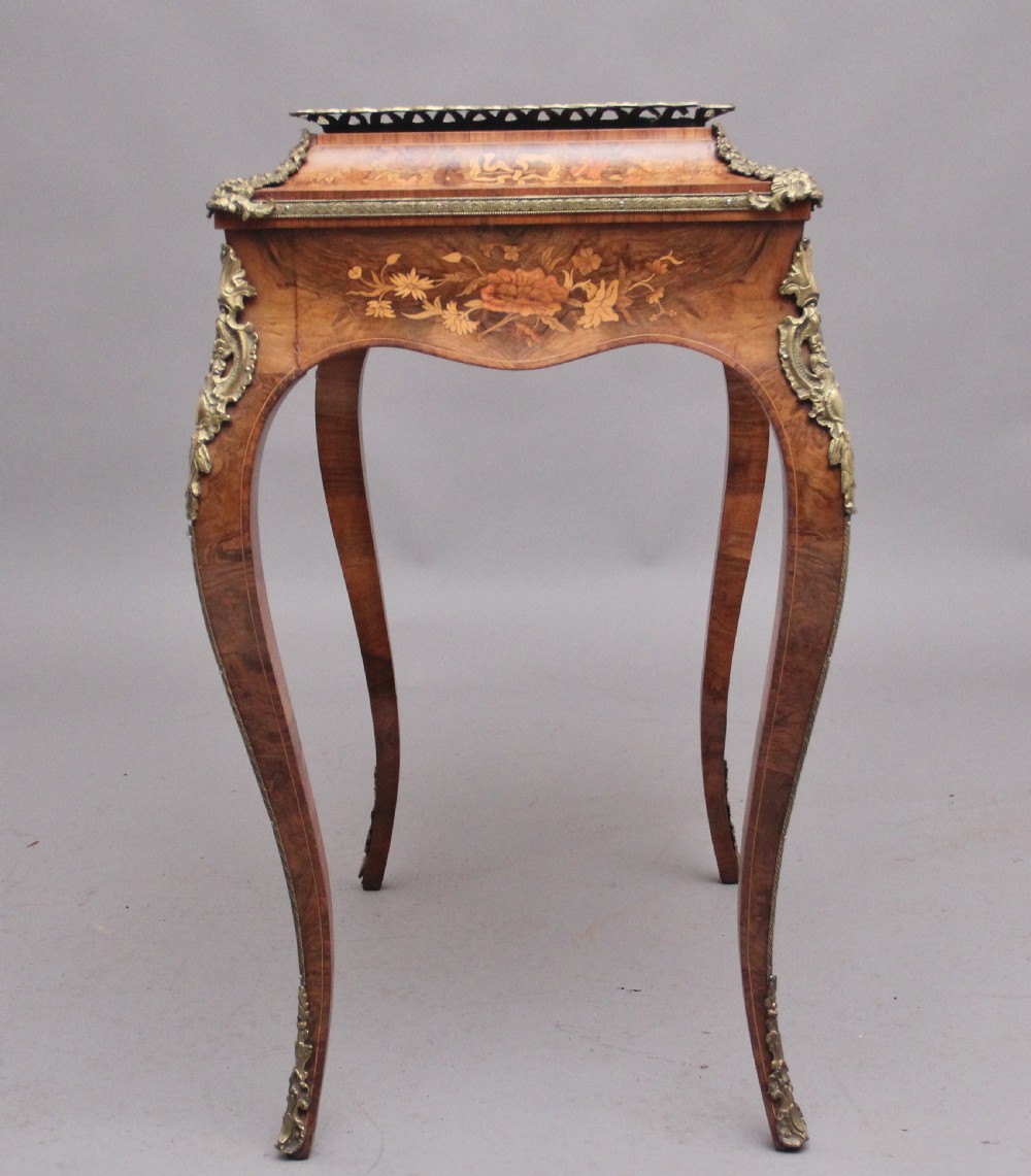 A 19th-century French Louis XV style burr walnut jardiniere table with floral marquetry inlay, brass gallery top, and gilt bronze mounts on cabriole legs. View IX