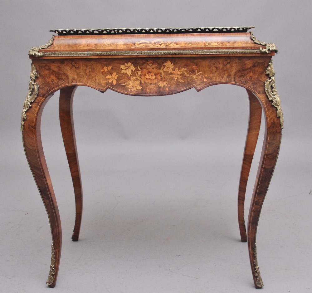 A 19th-century French Louis XV style burr walnut jardiniere table with floral marquetry inlay, brass gallery top, and gilt bronze mounts on cabriole legs. View XI