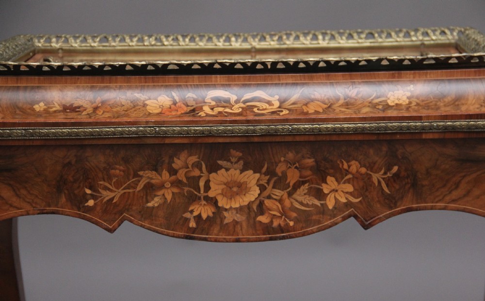 A 19th-century French Louis XV style burr walnut jardiniere table with floral marquetry inlay, brass gallery top, and gilt bronze mounts on cabriole legs. View XVI