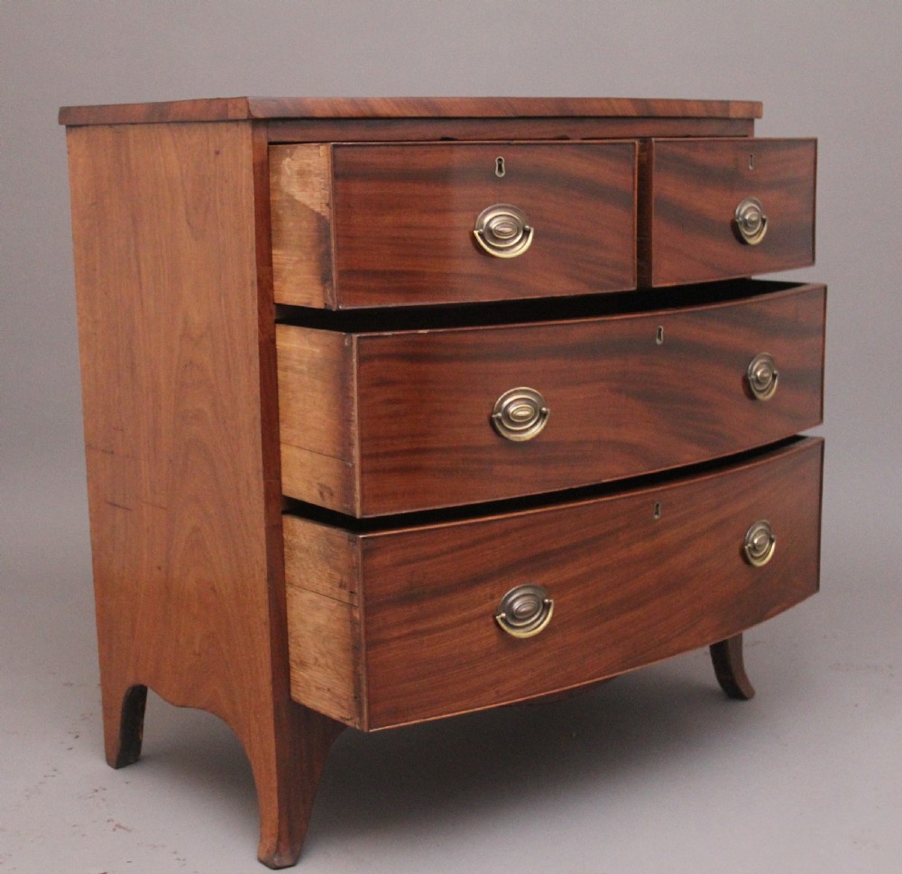 A 19th-century mahogany bowfront chest of drawers featuring two short drawers above two long drawers with oval brass handles and splayed bracket feet. View III
