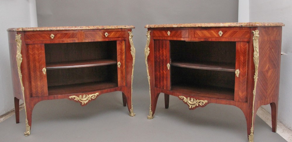A matching pair of 19th-century French kingwood commodes featuring herringbone parquetry veneer, gilt bronze mounts, and fitted marble tops. View IV