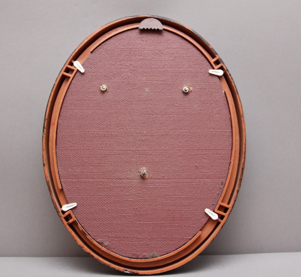 An oval framed copper plaque featuring a raised profile relief of Queen Victoria surrounded by British Royal heraldry and Commonwealth inscriptions. View III