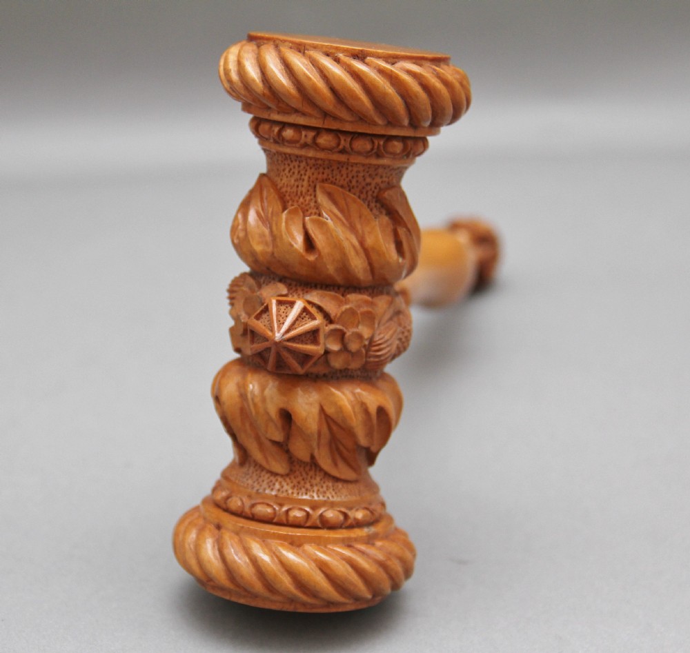 A 19th-century ceremonial set featuring an intricately hand-carved wooden mallet with foliate motifs and a matching carved wooden-handled steel chisel. View IV