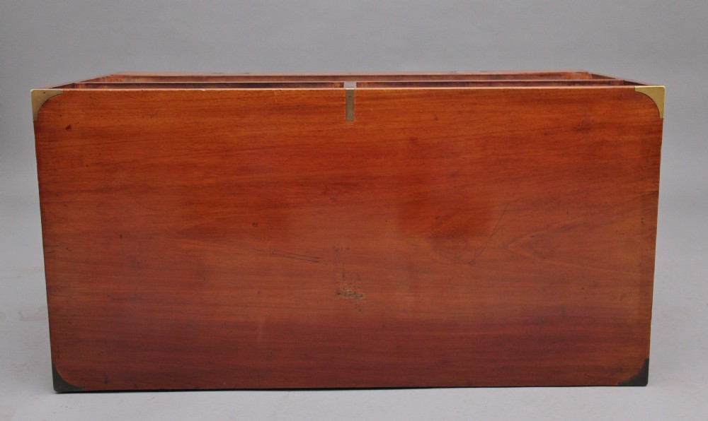 A nineteenth-century mahogany military secretaire chest in two sections with brass corners, flush brass handles, turned feet, and an extended writing drawer. View VIII