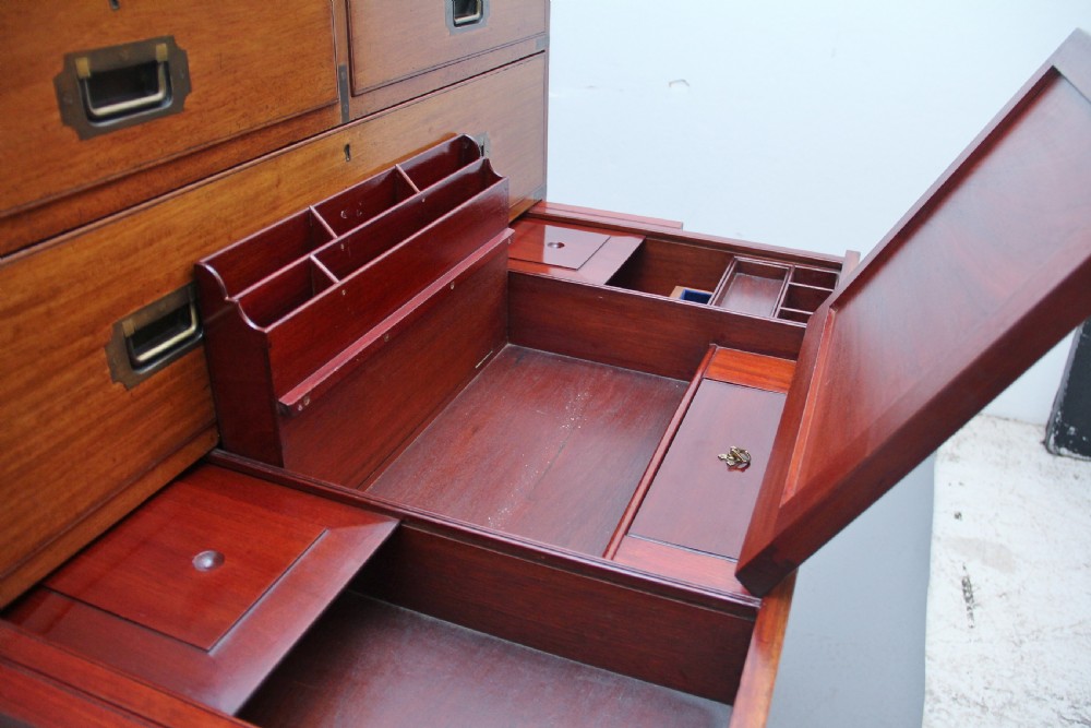 A nineteenth-century mahogany military secretaire chest in two sections with brass corners, flush brass handles, turned feet, and an extended writing drawer. View XIII