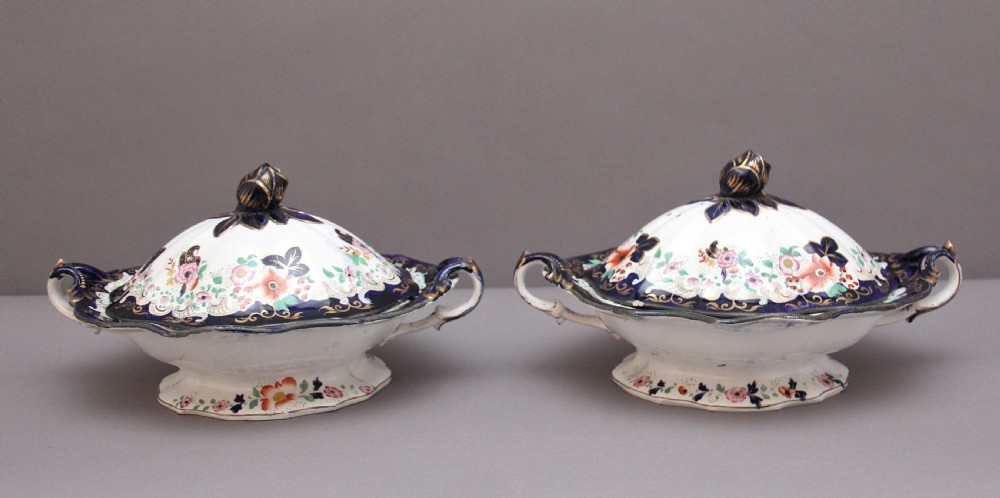 A pair of 19th-century white and cobalt blue ironstone tureens featuring hand-painted floral decoration, gilt accents, moulded handles, and flower bud finials. View IV