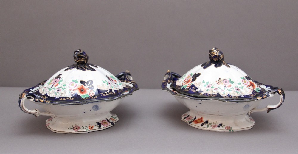 A pair of 19th-century white and cobalt blue ironstone tureens featuring hand-painted floral decoration, gilt accents, moulded handles, and flower bud finials. View VII
