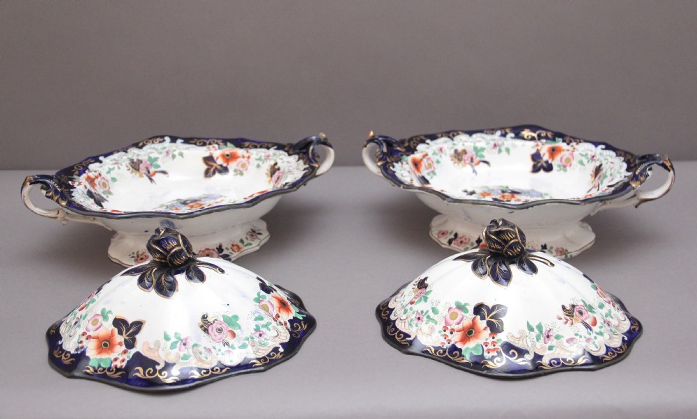 A pair of 19th-century white and cobalt blue ironstone tureens featuring hand-painted floral decoration, gilt accents, moulded handles, and flower bud finials. View VIII