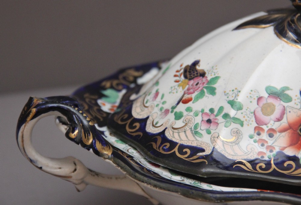 A pair of 19th-century white and cobalt blue ironstone tureens featuring hand-painted floral decoration, gilt accents, moulded handles, and flower bud finials. View XIII