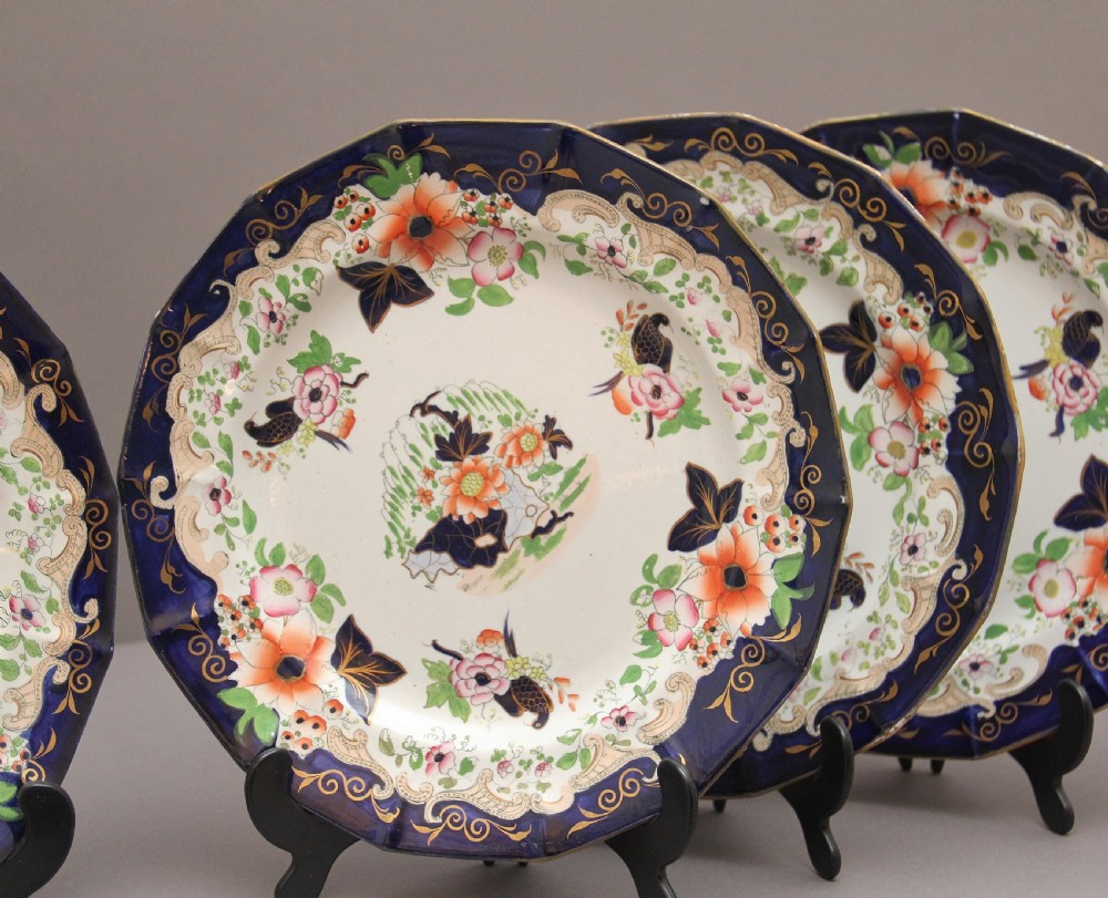 A set of six octagonal 19th-century Masons ironstone plates featuring cobalt blue borders, orange and pink floral transfer motifs, and gilt highlights. View II