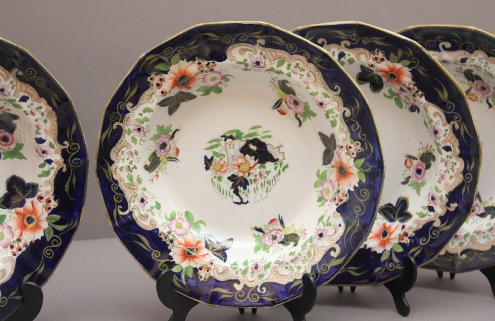 A set of six octagonal 19th-century Masons ironstone soup bowls featuring dark blue borders with gold scrollwork and hand-painted floral motifs. View II