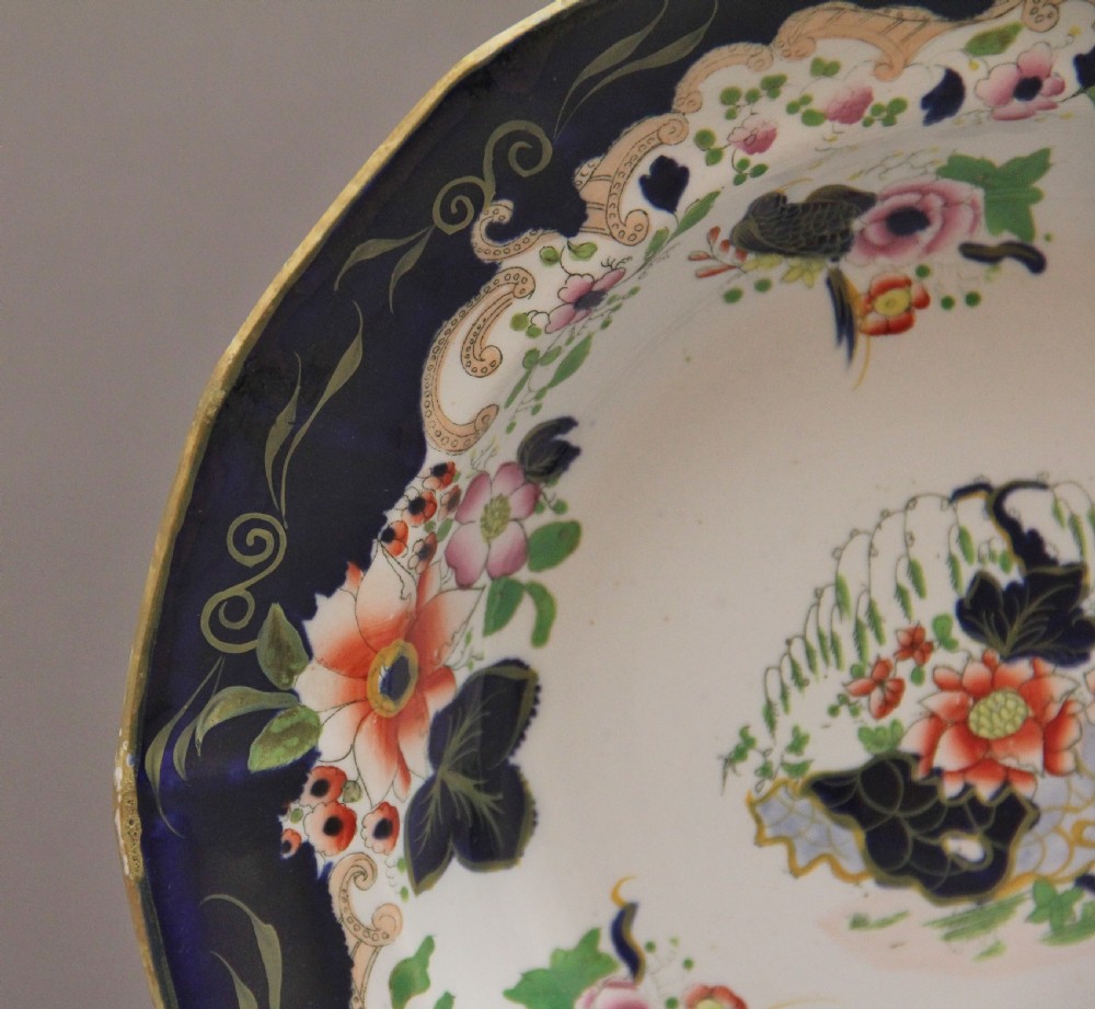 A set of six octagonal 19th-century Masons ironstone soup bowls featuring dark blue borders with gold scrollwork and hand-painted floral motifs. View III