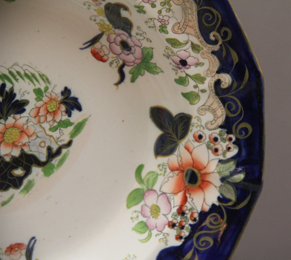 A set of six octagonal 19th-century Masons ironstone soup bowls featuring dark blue borders with gold scrollwork and hand-painted floral motifs. View IV