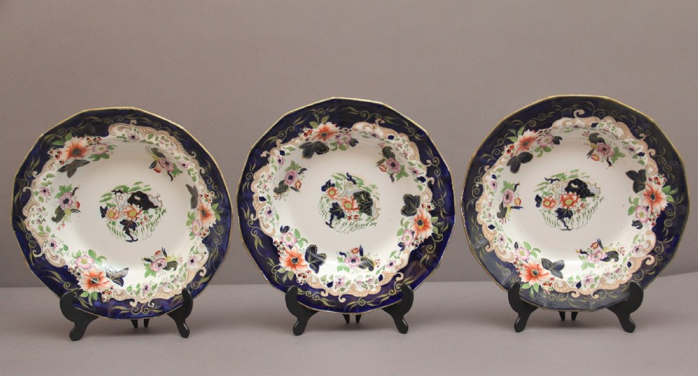 A set of six octagonal 19th-century Masons ironstone soup bowls featuring dark blue borders with gold scrollwork and hand-painted floral motifs. View V