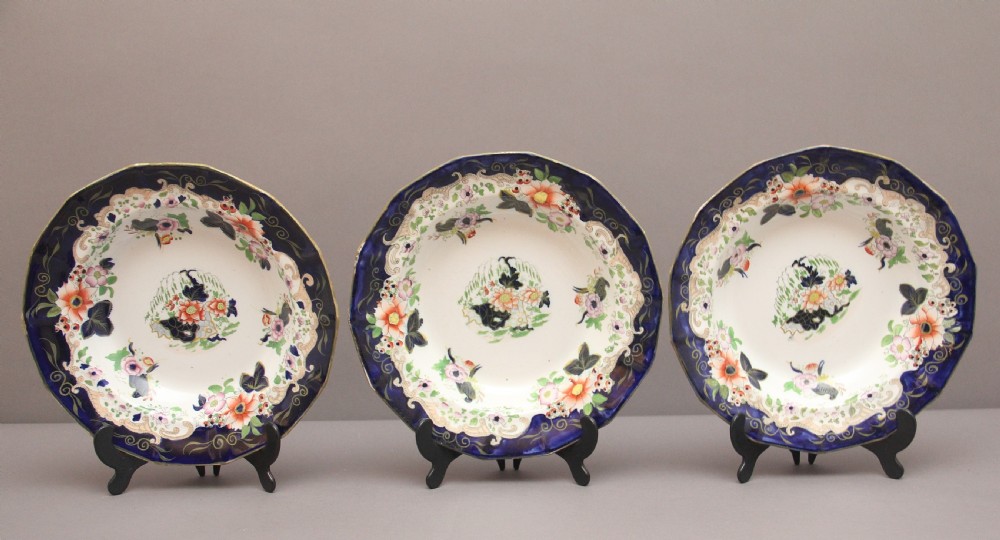 A set of six octagonal 19th-century Masons ironstone soup bowls featuring dark blue borders with gold scrollwork and hand-painted floral motifs. View VII